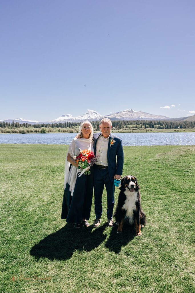 an elegant elopement couple with their dog with lake and mountain views in the backdrop in Oregon