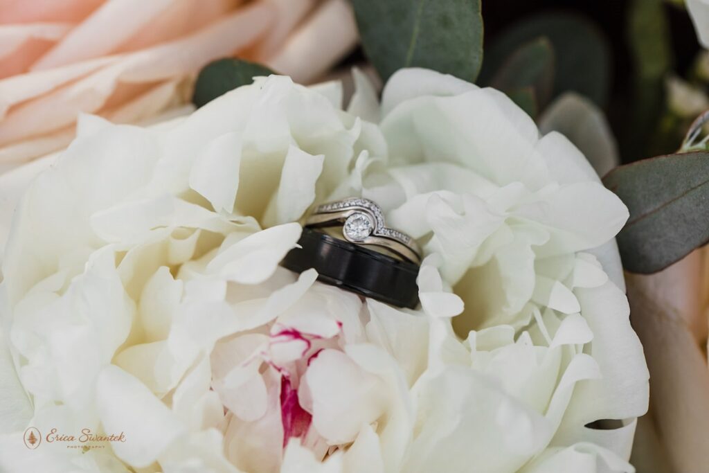 wedding rings in a white flower bloom