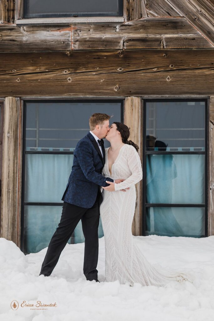 a cozy winter elopement with the couple surrounded by snow