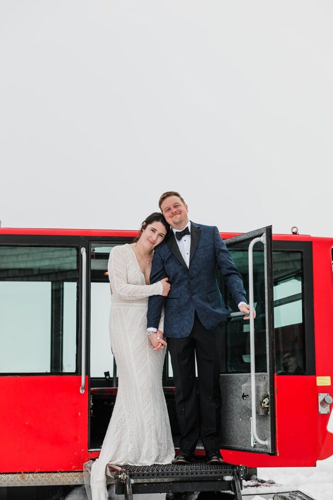 a cozy winter elopement with the couple surrounded by snow