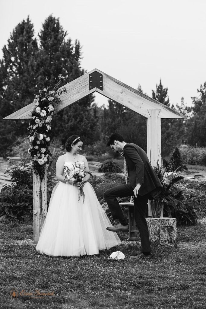 groom smashing glass during their Jewish inspired wedding ceremony