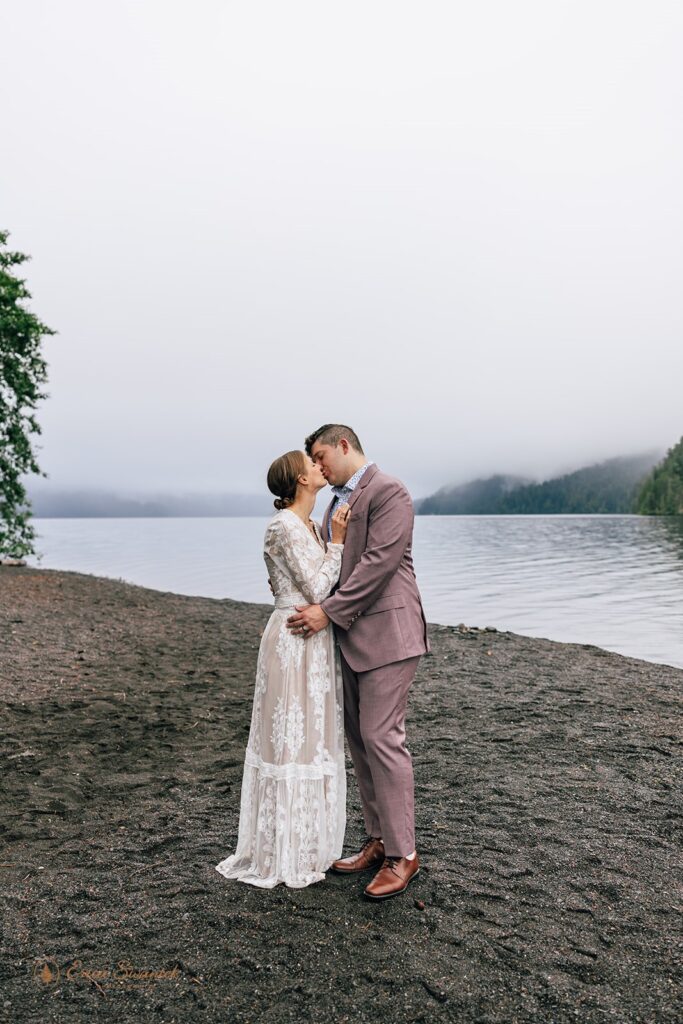 elopement couple kissing by lake crescent during their olympic national park elopement