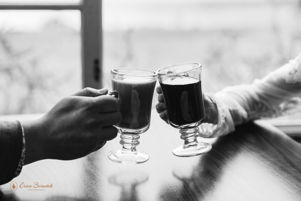 close up of the couple cheering with coffee cups