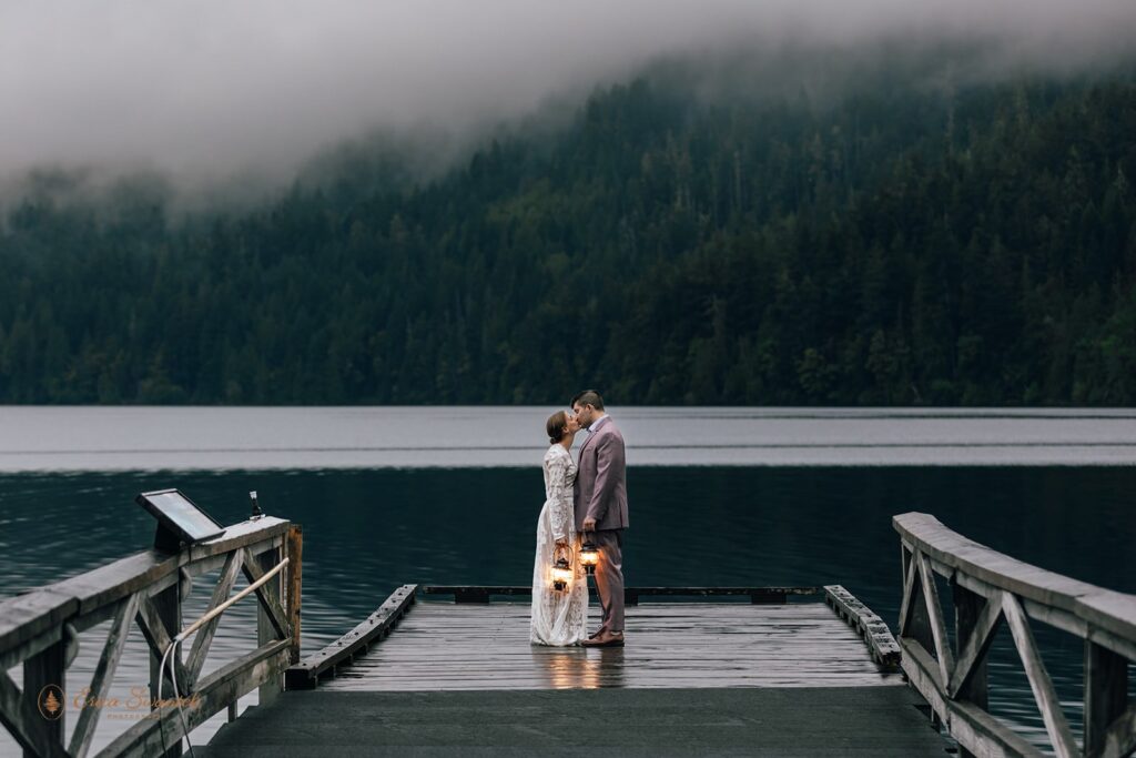 moody Olympic National Park elopement couple standing with lanterns at Lake Crescent