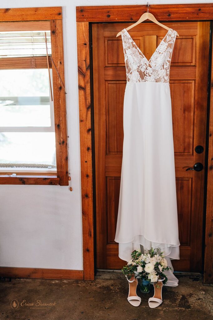 wedding dress hung at the door frame