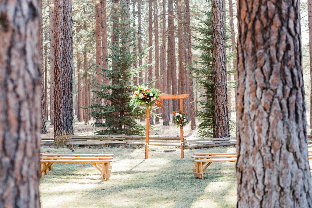 outdoor ceremony bench set up at fivepine lodge wedding venue