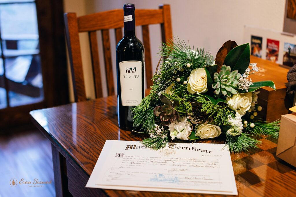 elopement details of the bouquet, marriage certificate and a bottle of bubbly