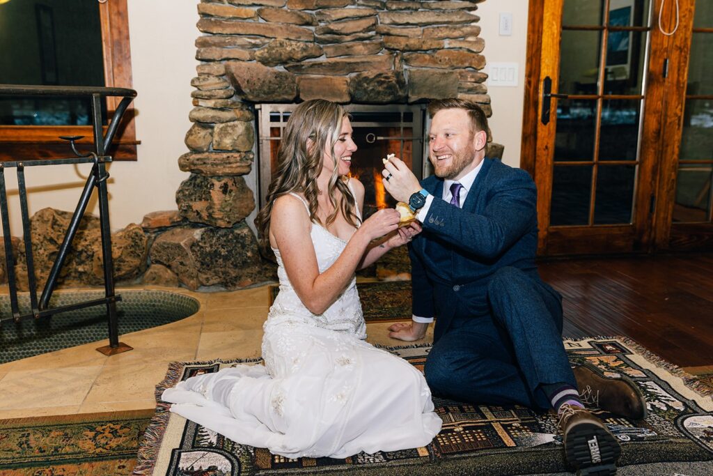 bride and groom feeding each other cake