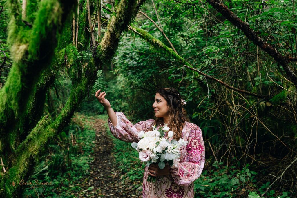 bride and groom and their dog at the rainforest trail surrounded by lush greenery