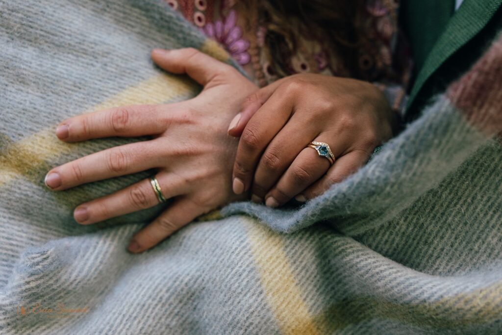 cozy bride and groom hugging under a blanket