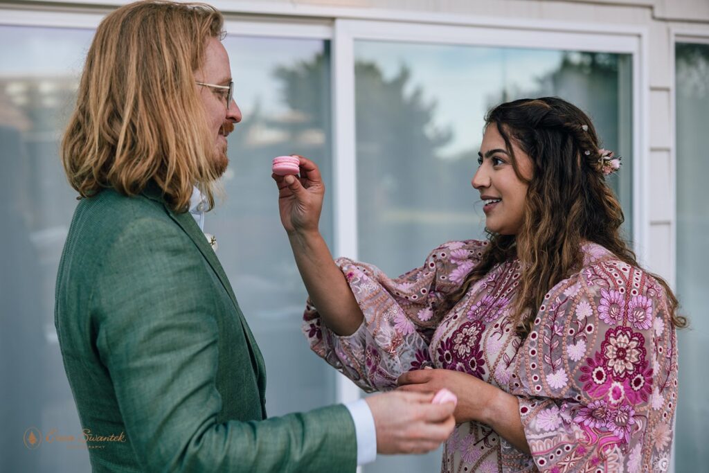 bride and groom feeding each other sweet treats