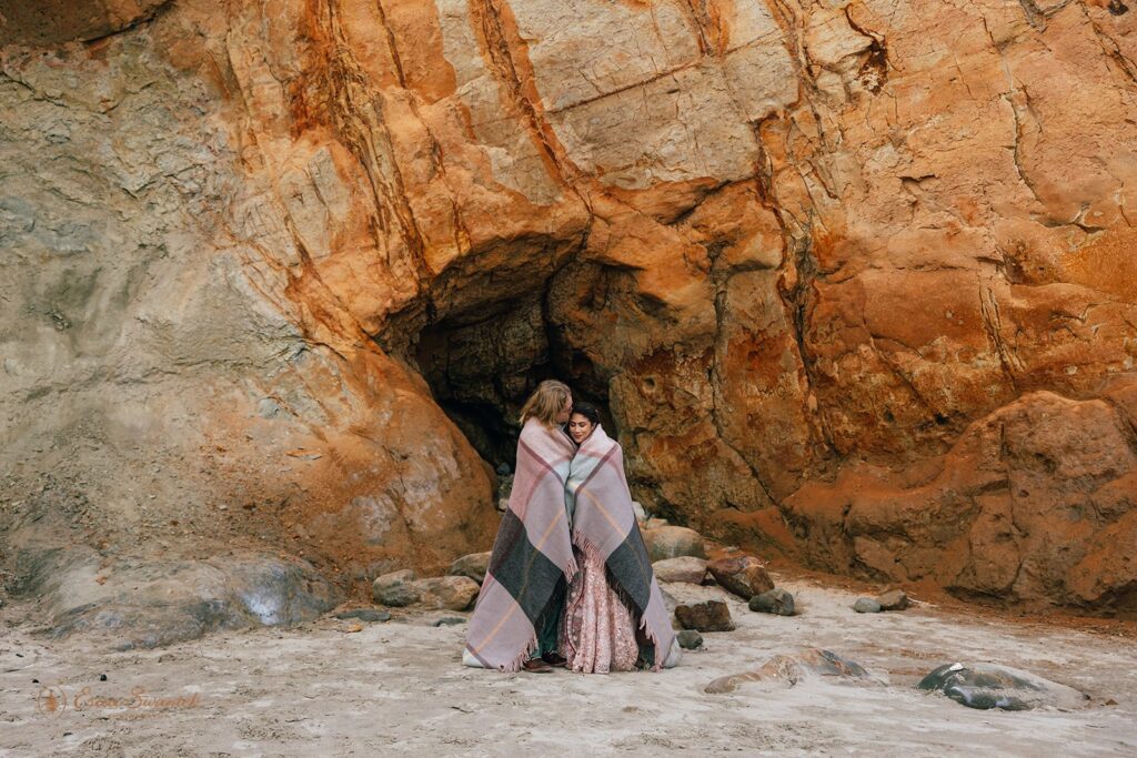 bride and groom snuggling under the blanket 