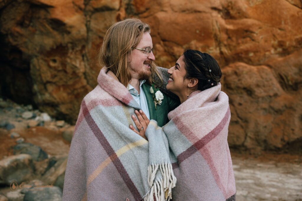 bride and groom snuggling under the blanket 