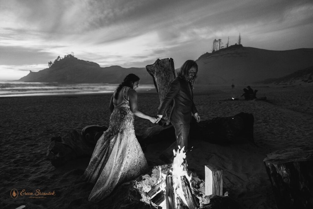 bride and groom by a campfire