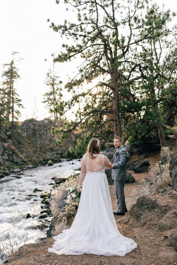 candid bride and groom moments during their bend elopement day walking along the Deschutes River Trail in the Deschutes National Forest