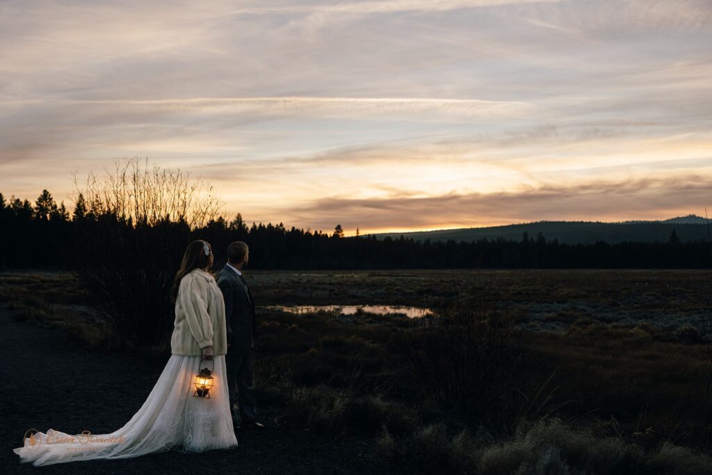 bride and groom evening photos with lanterns with stunning bend, or, landscapes in the backdrop