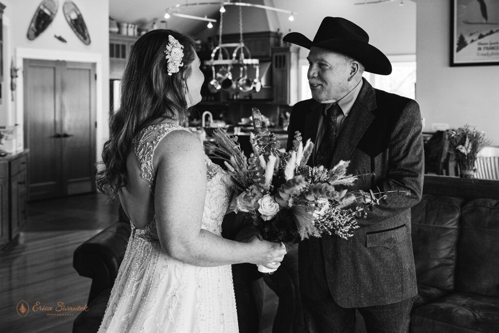 black and white image of bride and dad first look