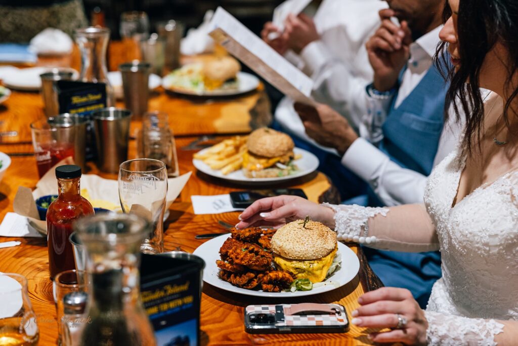 elopement couple and some guests enjoying a meal together at the brewery