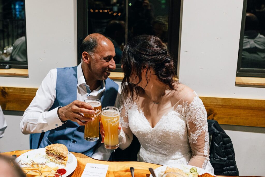 elopement couple and some guests enjoying a meal together at the brewery