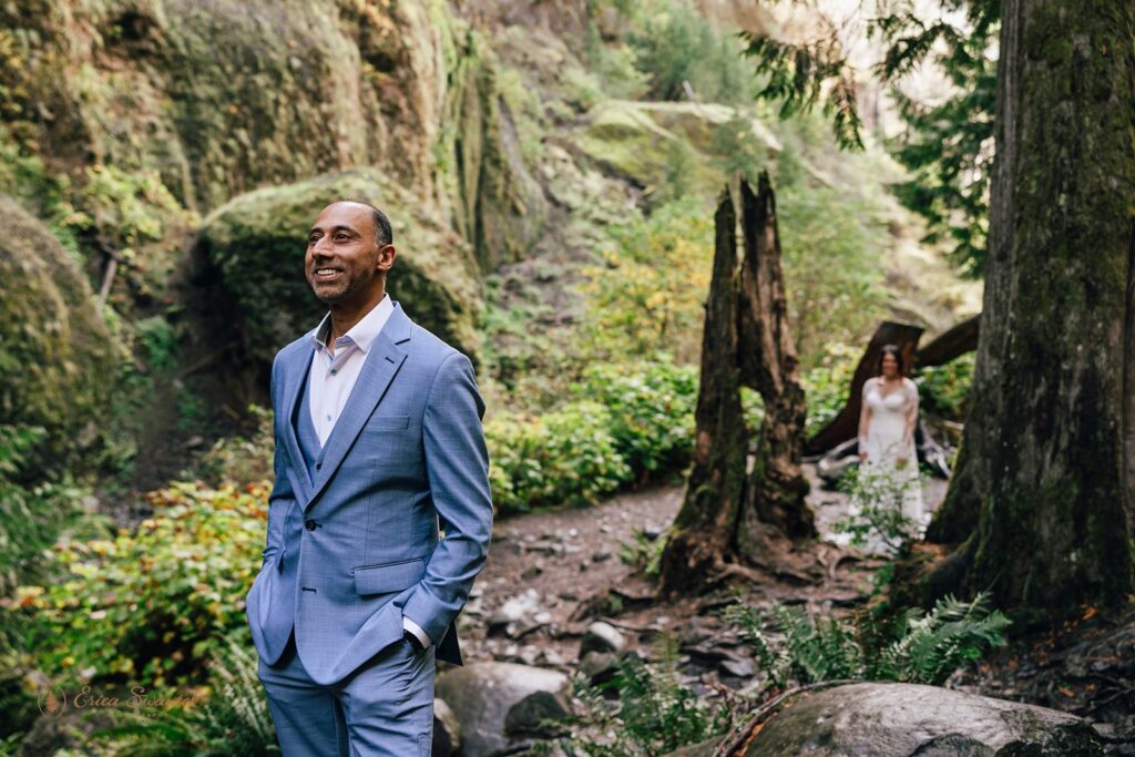 bride and groom first look by the waterfall during their waterfall elopement day