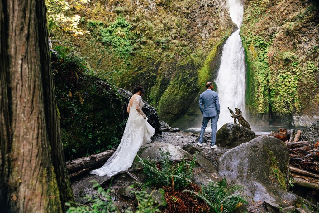 bride and groom first look by the waterfall during their waterfall elopement day