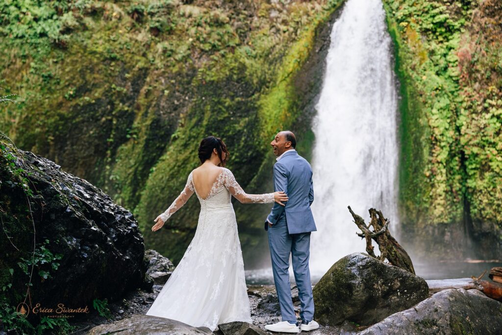 bride and groom first look by the waterfall during their waterfall elopement day