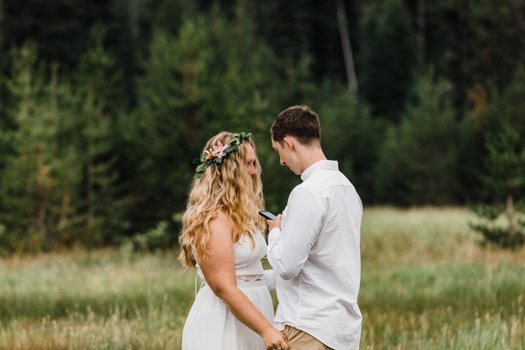 intimate elopement ceremony in a field with mountain backdrops at Sparks Lake 