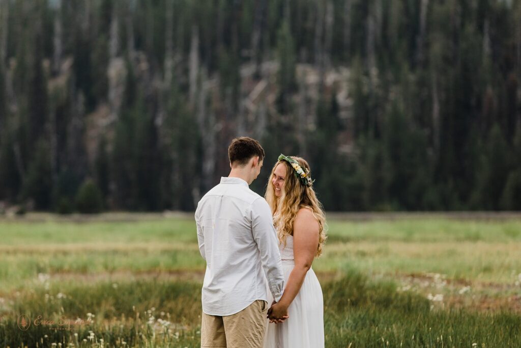 intimate elopement ceremony in a field with mountain backdrops at Sparks Lake 