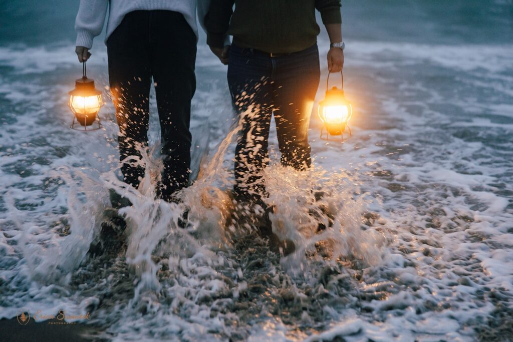 moody elopement couple with lanterns along oregon coast