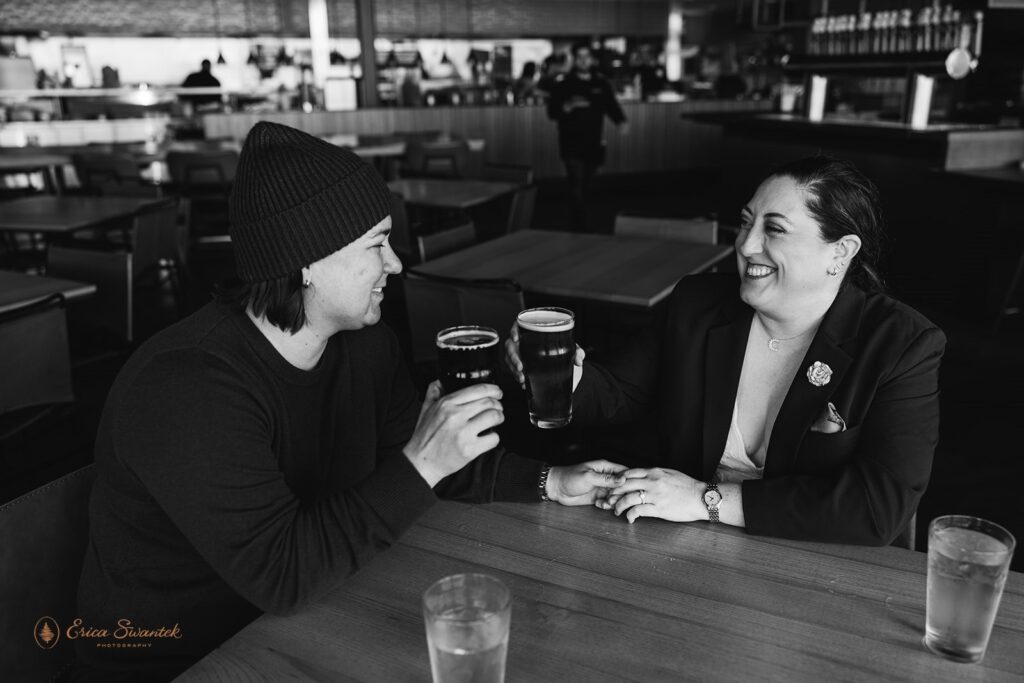 elopement couple enjoying beers at a brewery