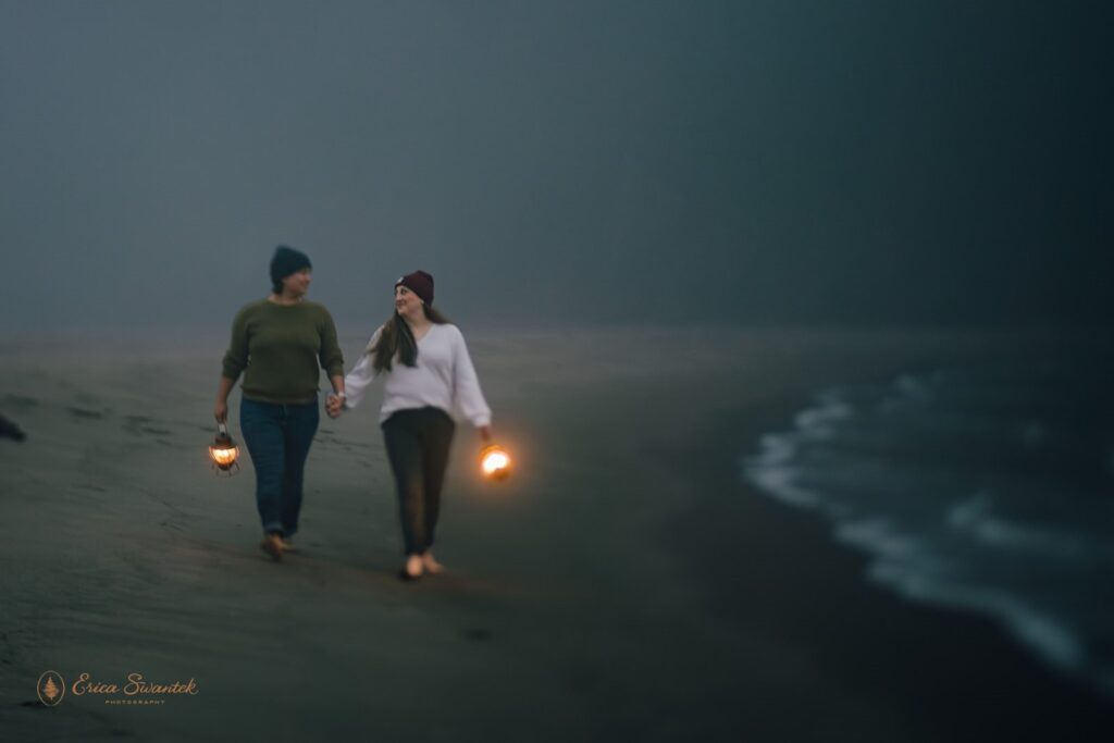 moody elopement couple with lanterns along oregon coast