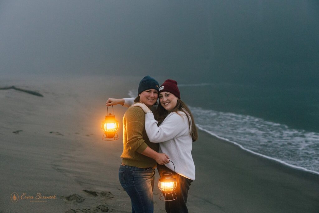 moody elopement couple with lanterns along oregon coast