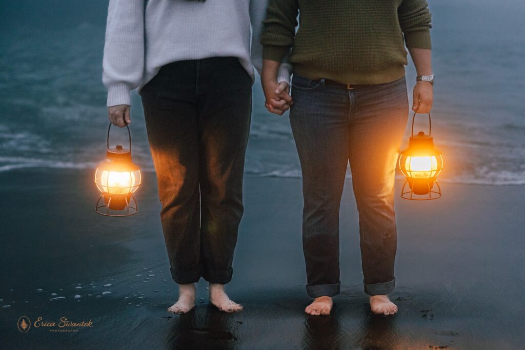 moody elopement couple with lanterns along oregon coast