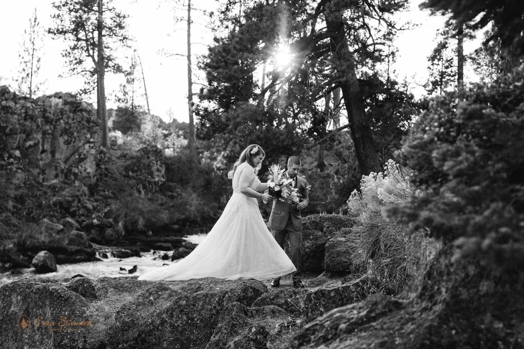 dreamy bride and groom moments by a wild running river at Dillon Falls