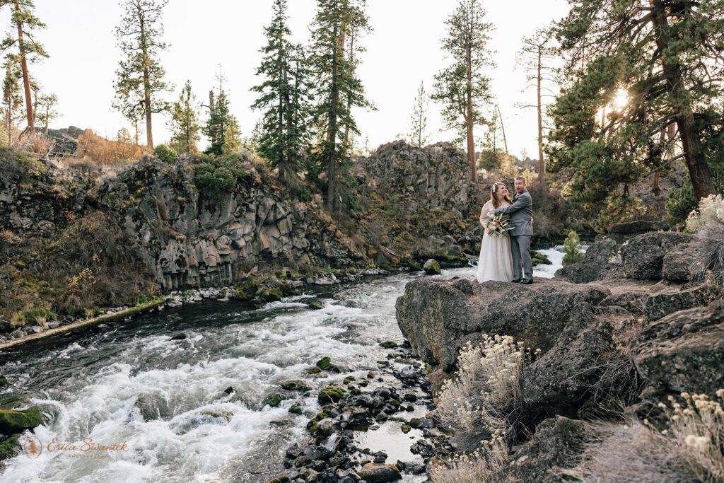 dreamy bride and groom moments by a wild running river at Dillon Falls