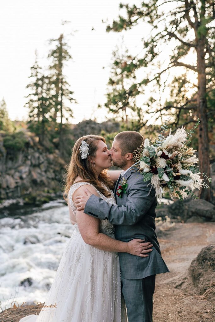 dreamy bride and groom moments by a wild running river at Dillon Falls