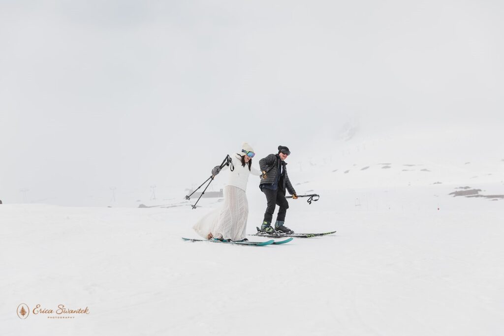 elopement couple going down the mountain on skis during their winter elopement in mt. hood
