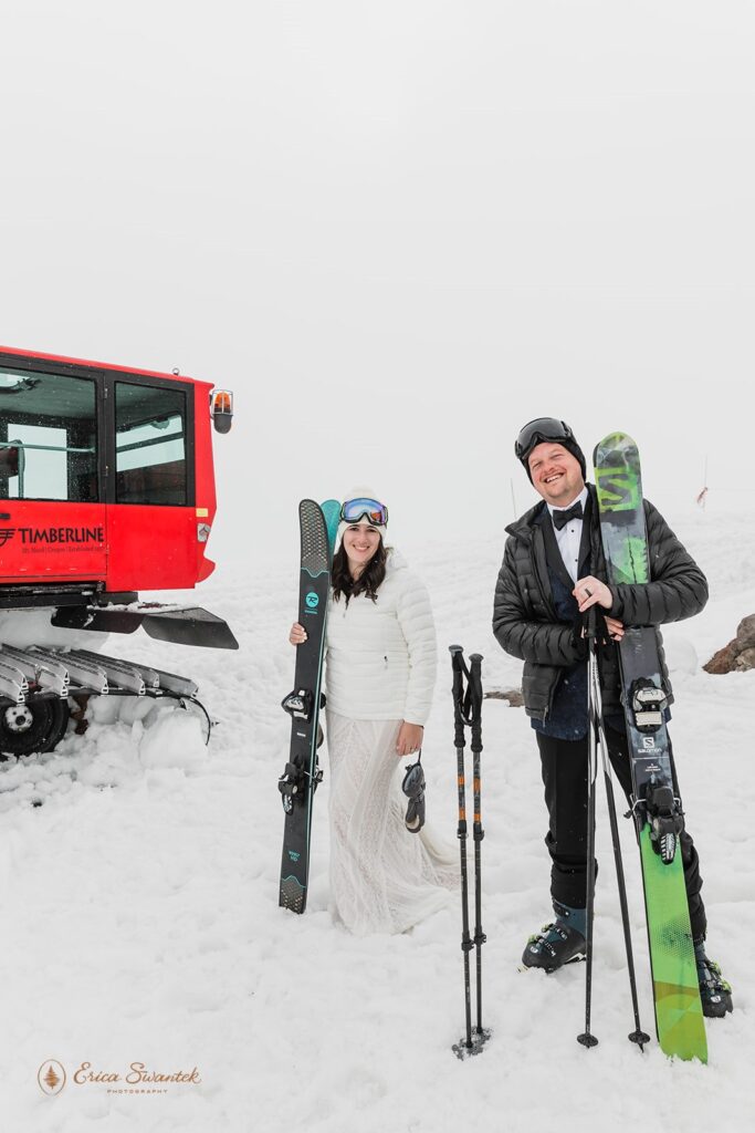 winter elopement couple posing with their skis in mt. hood
