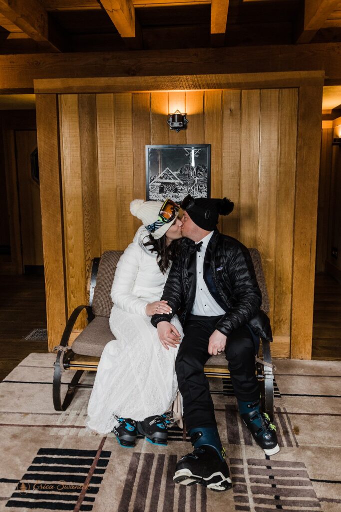 bride and groom sitting in their ski attire in their cozy rustic lodge, preparing to head out to the mountain