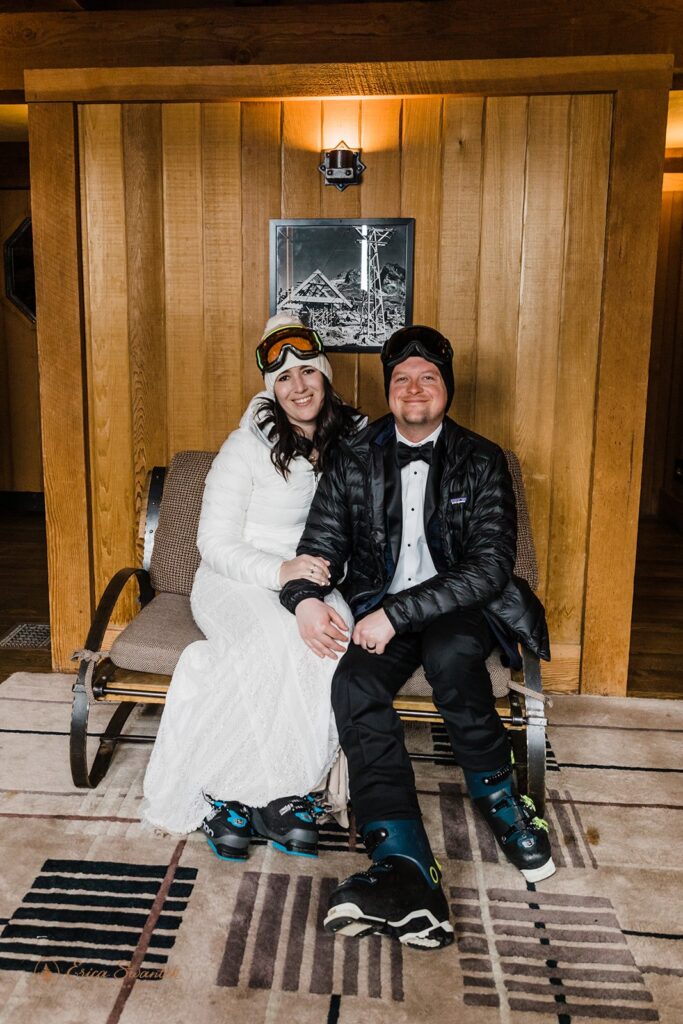 bride and groom sitting in their ski attire in their cozy rustic lodge, preparing to head out to the mountain