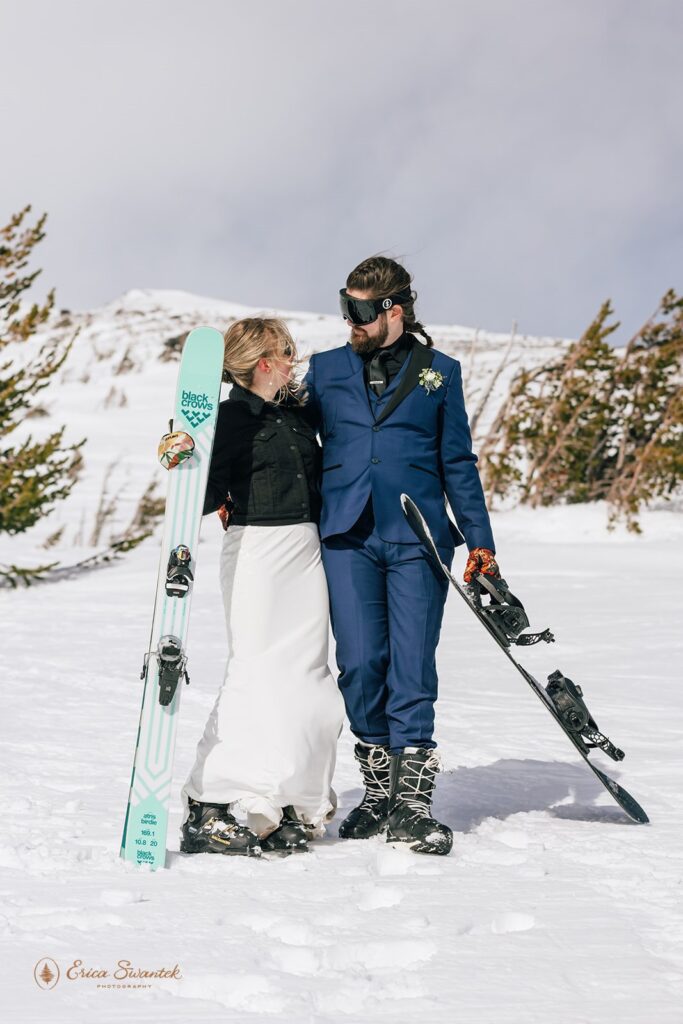 adventurous mt. hood elopement in the winter on the mountain, couple posing with their skis and snowboard