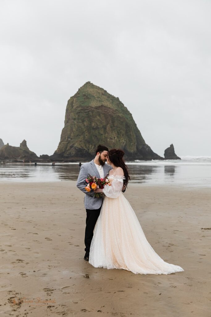 elopement couple in cannon beach, one of the most beautiful and moody oregon elopement locations