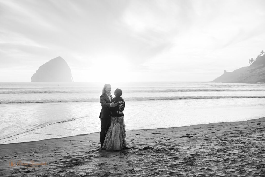 couple gazing at the ocean sunset during their Oregon coast elopement