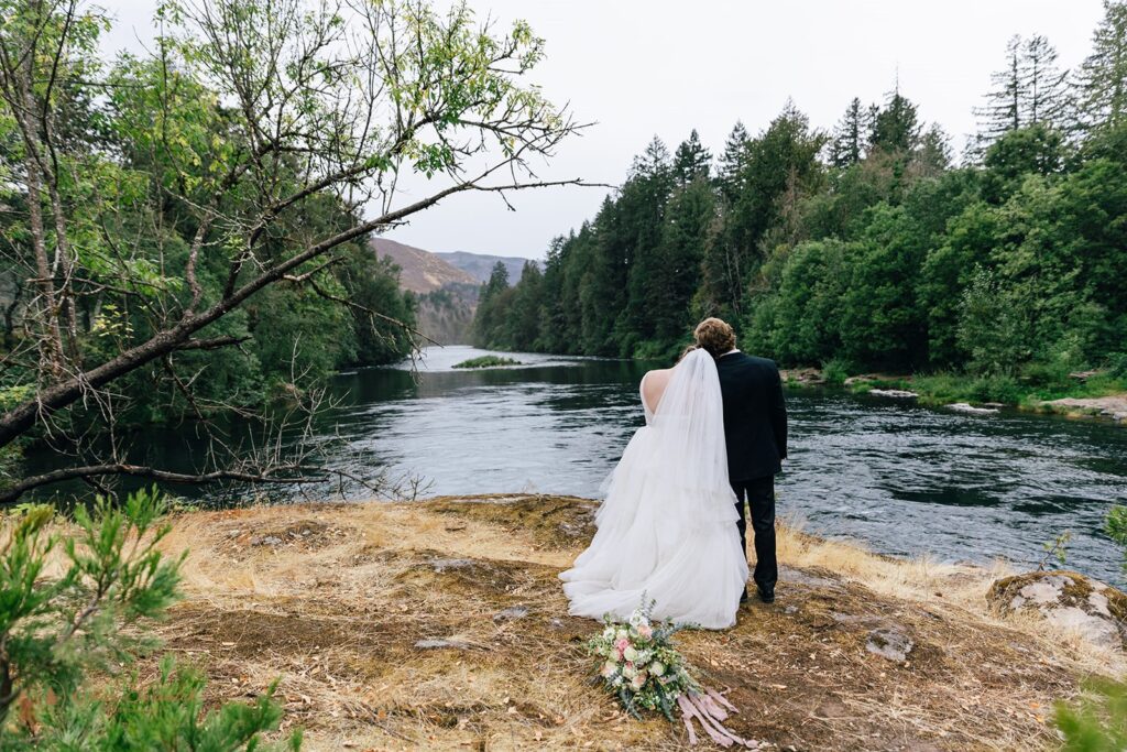 romantic bride and groom at the McKenzie River shore for their Oregon Elopement 