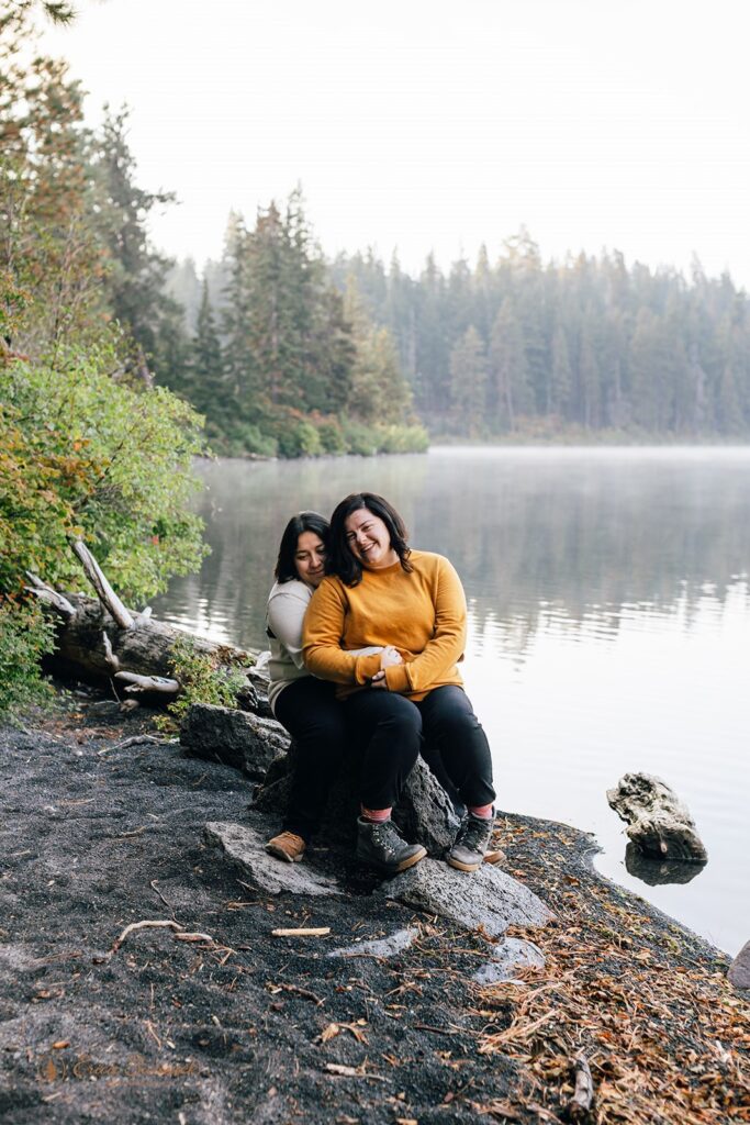 romantic couple being cuddly at the lakeside of suttle lake lodge