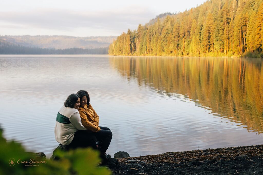 romantic couple being cuddly at the lakeside of suttle lake lodge