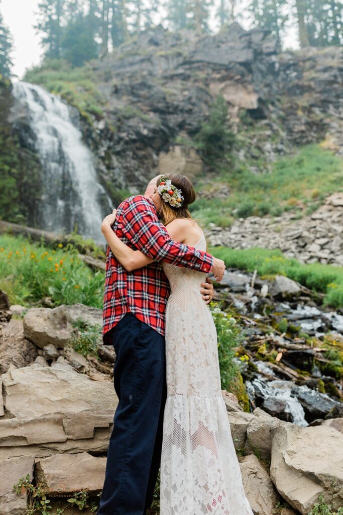 forest elopement ceremony by a waterfall in crater lake national park