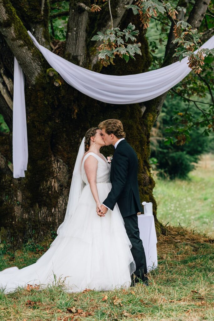 whitewater ranch outdoor wedding ceremony by a large tree