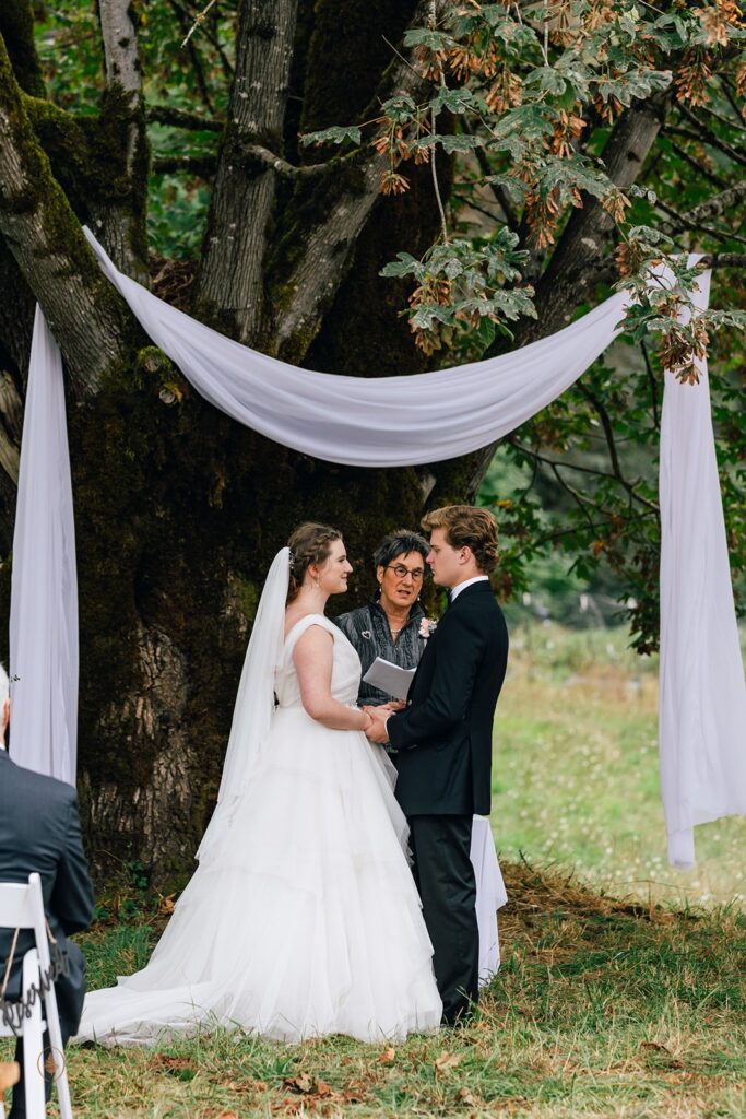 whitewater ranch outdoor wedding ceremony by a large tree