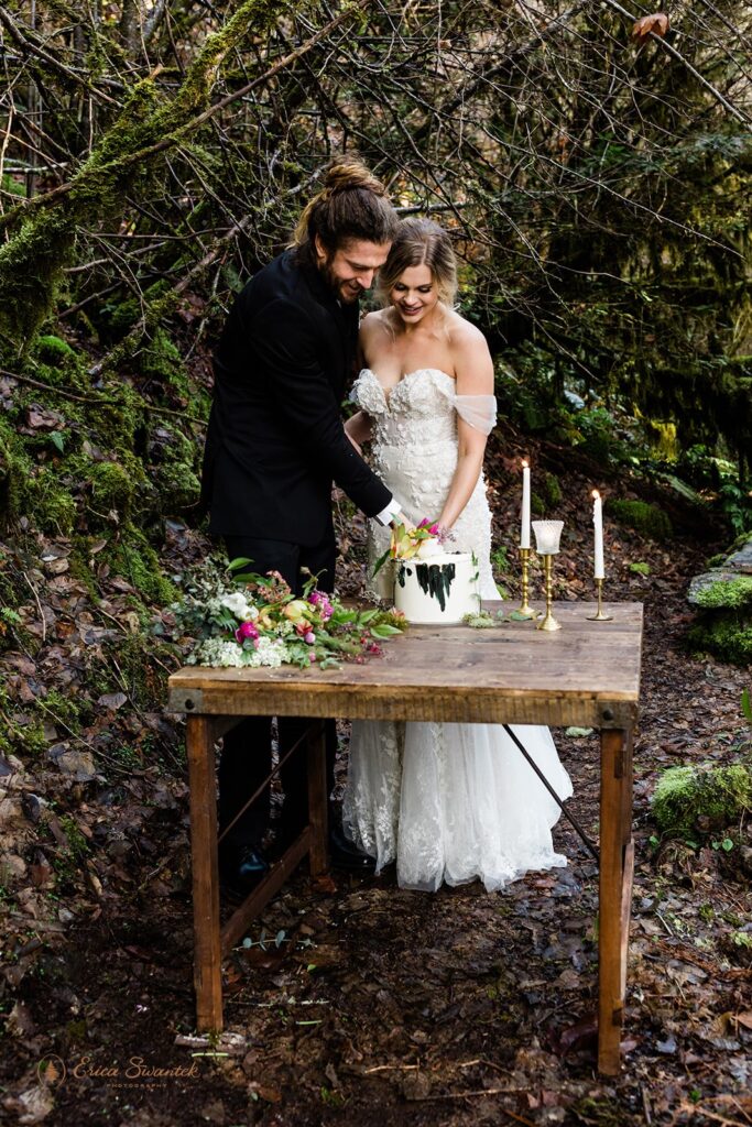 bride and groom cutting a small cake during their Oregon forest elopement at Belknap Hot Springs